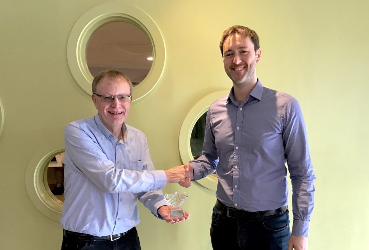 Rick Maltby of TBT Marketing hands Neil the award